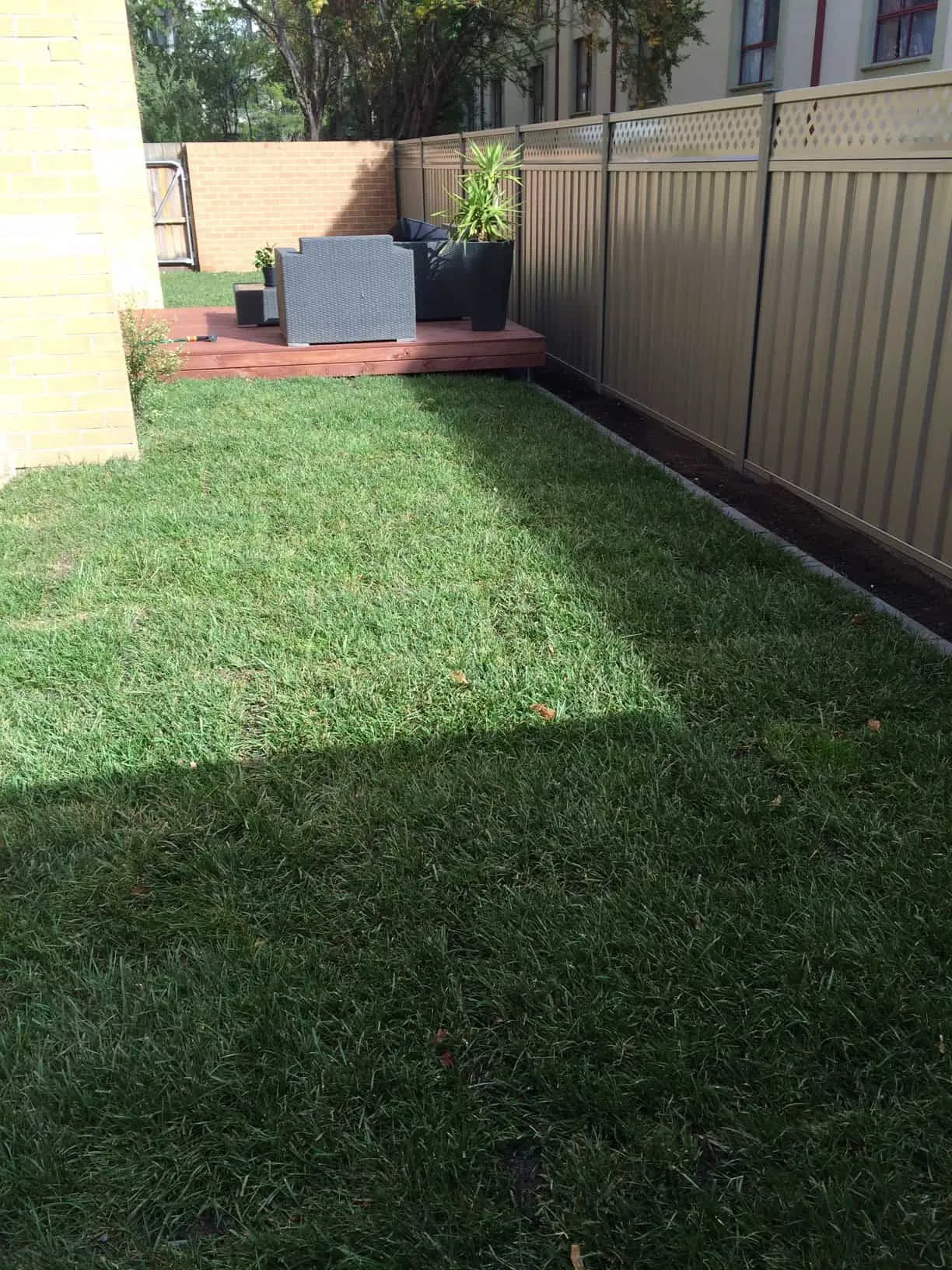 The same strip finished with a timber deck, new lawn and screening